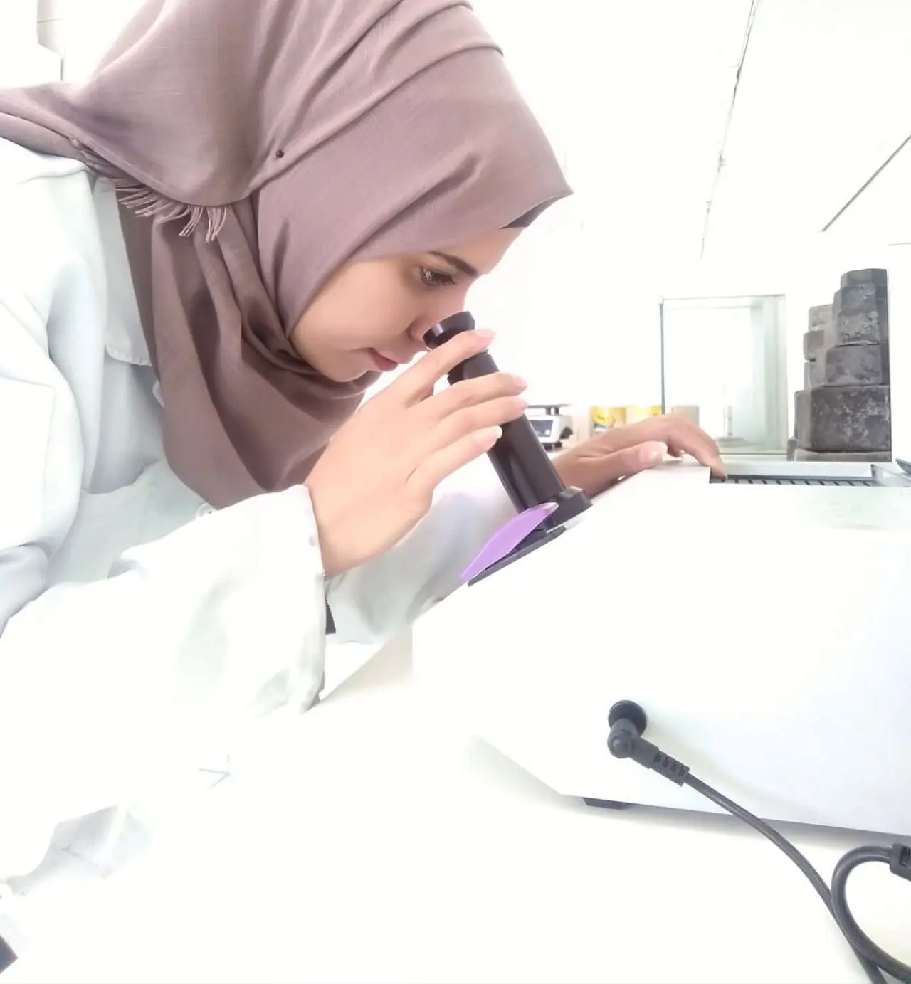 AVO laboratory specialist examining an oil sample